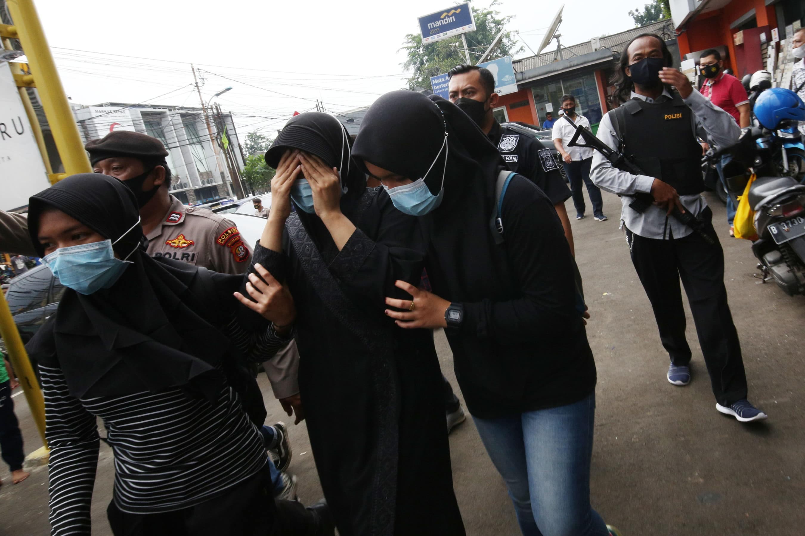 Salah satu keluga terduga teroris diamankan petugas kepolisian saat penggerebekan di kawasan Condet, Jakarta, Senin (29/3/2021). Dari hasil penggerebekan ditemukan barang bukti berupa lima bom aktif dan jenis bom sumbu yang siap digunakan, lima toples bes - Image